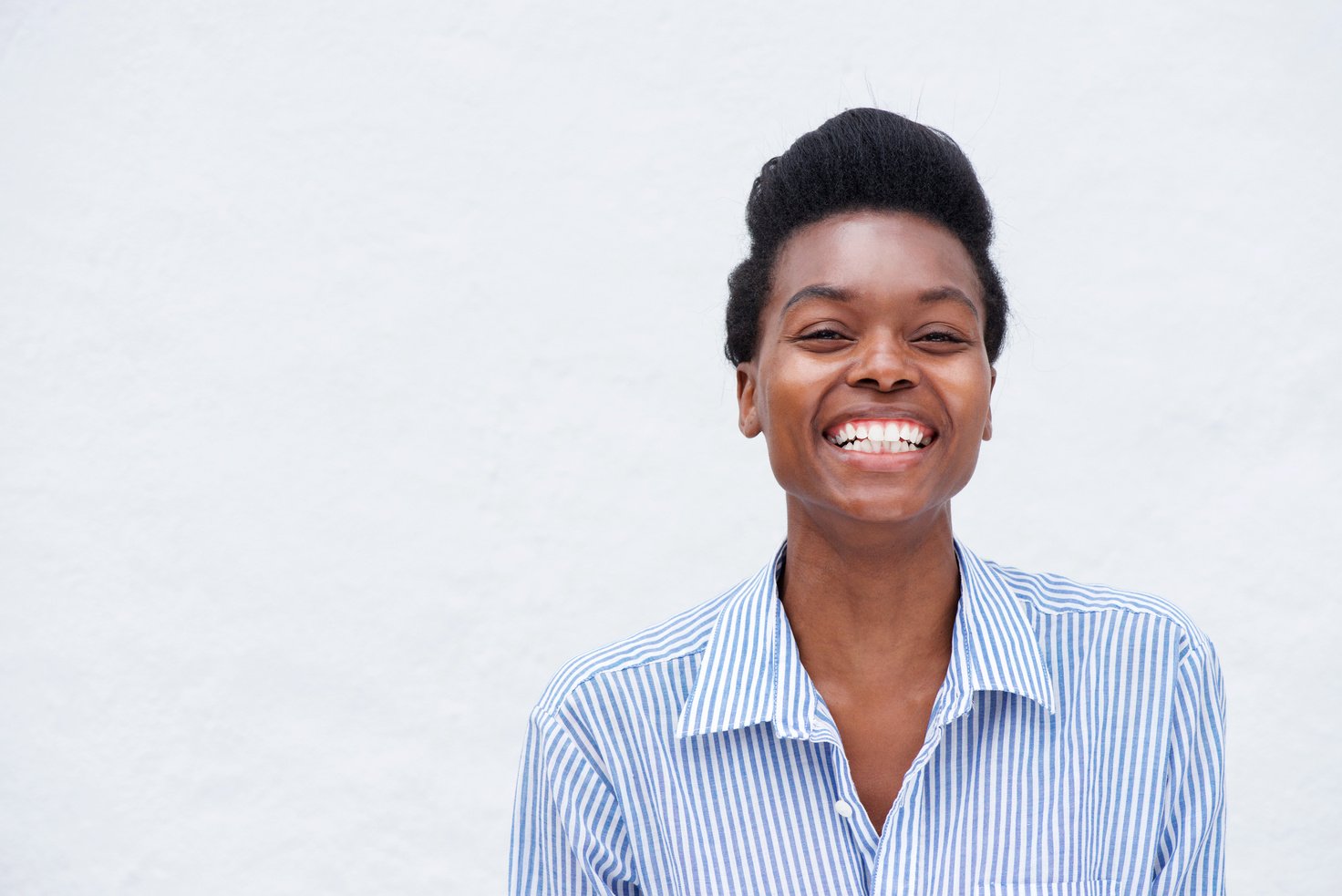 Laughing Young Woman against White Background